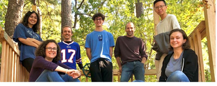 Grandl lab members posing with forest in the background