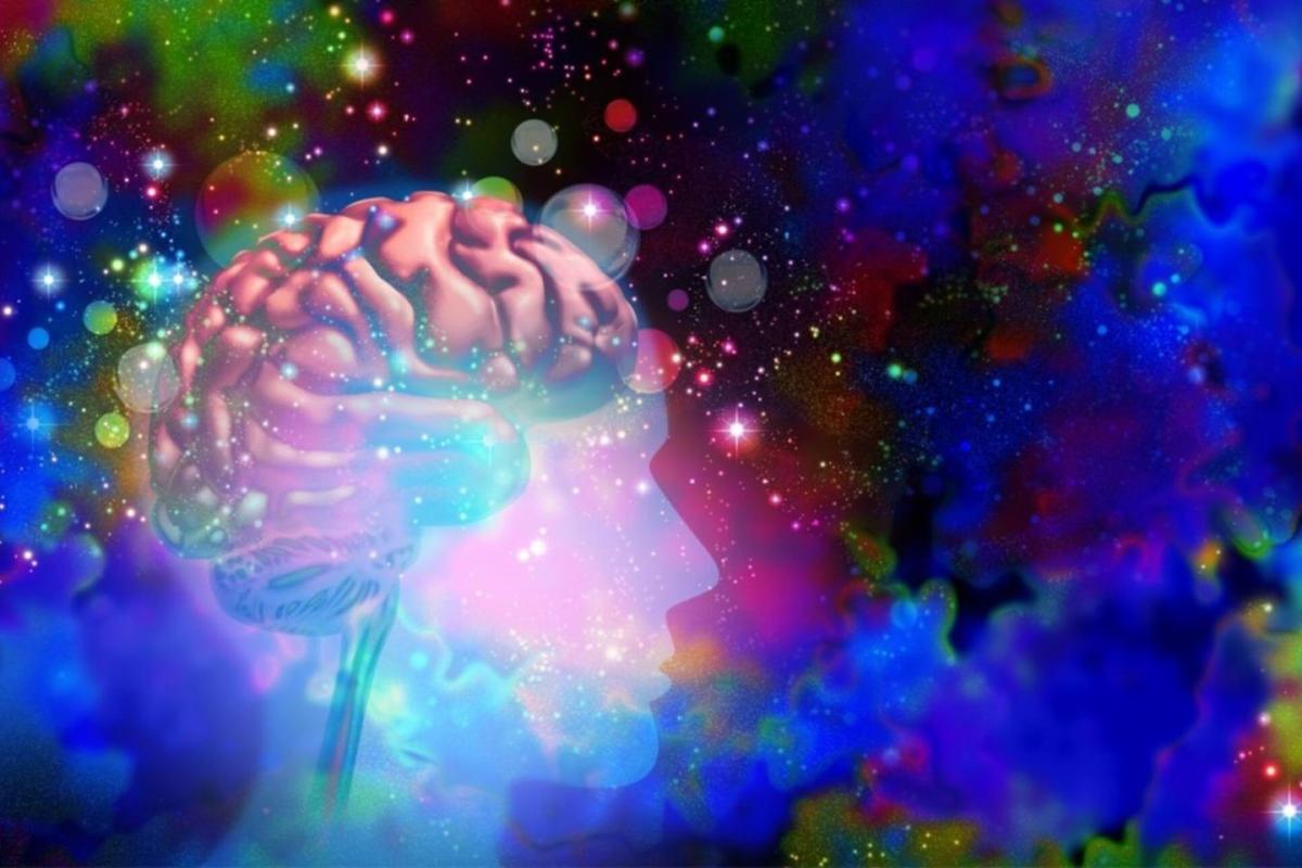 Image of human brain surrounded by swirling psychedellic colors and stars