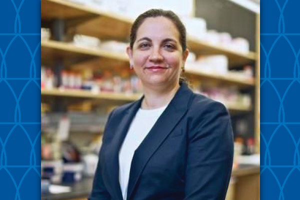 Cagla Eroglu standing by lab shelves with glassware