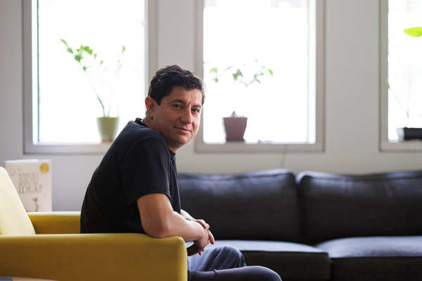 Diego Bohorquez seated on a couch