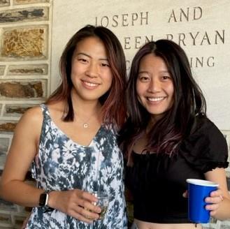 Aja Pragana and Medy Mu in front of Joseph & Kathleen Bryan Building sign