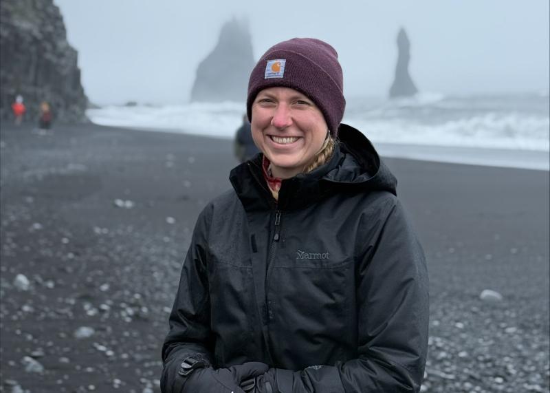 Kaitlyn Fouke standing on a beach in Iceland all bundled up.
