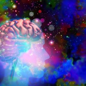 Image of human brain surrounded by swirling psychedellic colors and stars