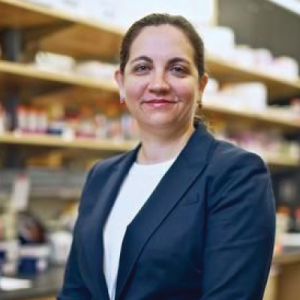 Cagla Eroglu standing by lab shelves with glassware