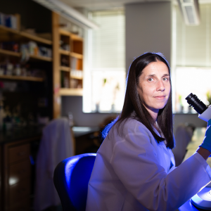 Faculty member Kate Meyer at the microscope