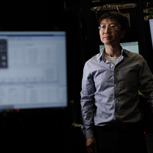 Nuo Li standing by lab equipment