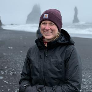 Kaitlyn Fouke standing on a beach in Iceland all bundled up.