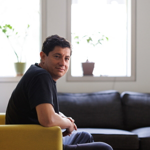 Diego Bohorquez seated on a couch
